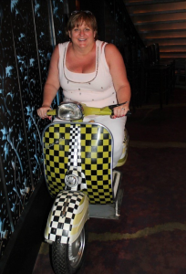 Julie Pulmano sitting on a scooter before her bariatric surgery