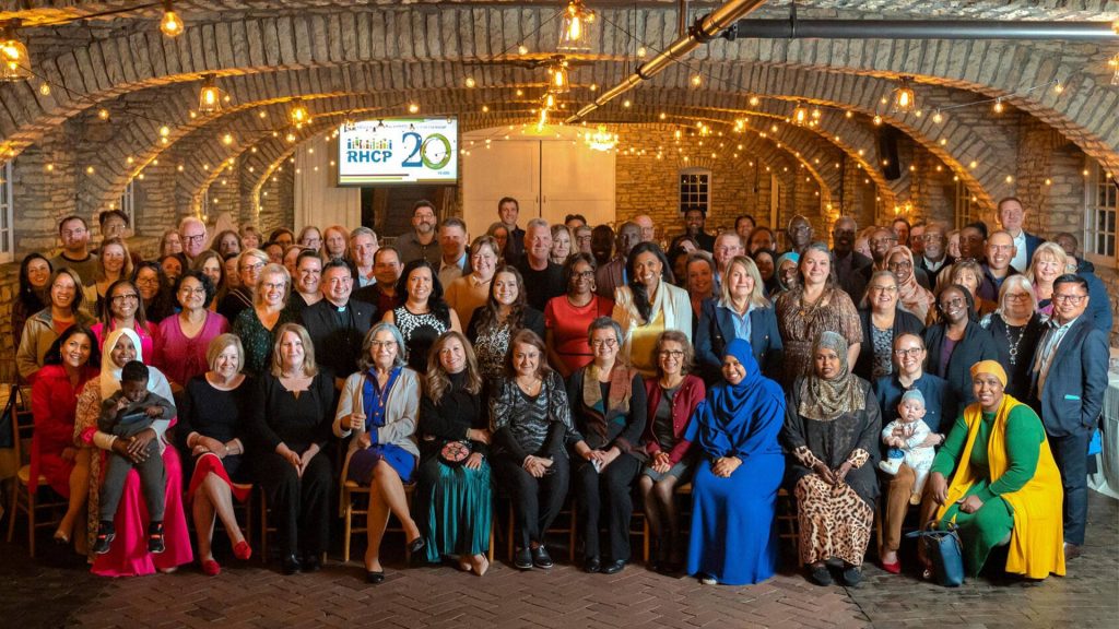 Approximately 100 people pose for a group photo at the Rochester Healthy Community Partnership 20th anniversary event. 