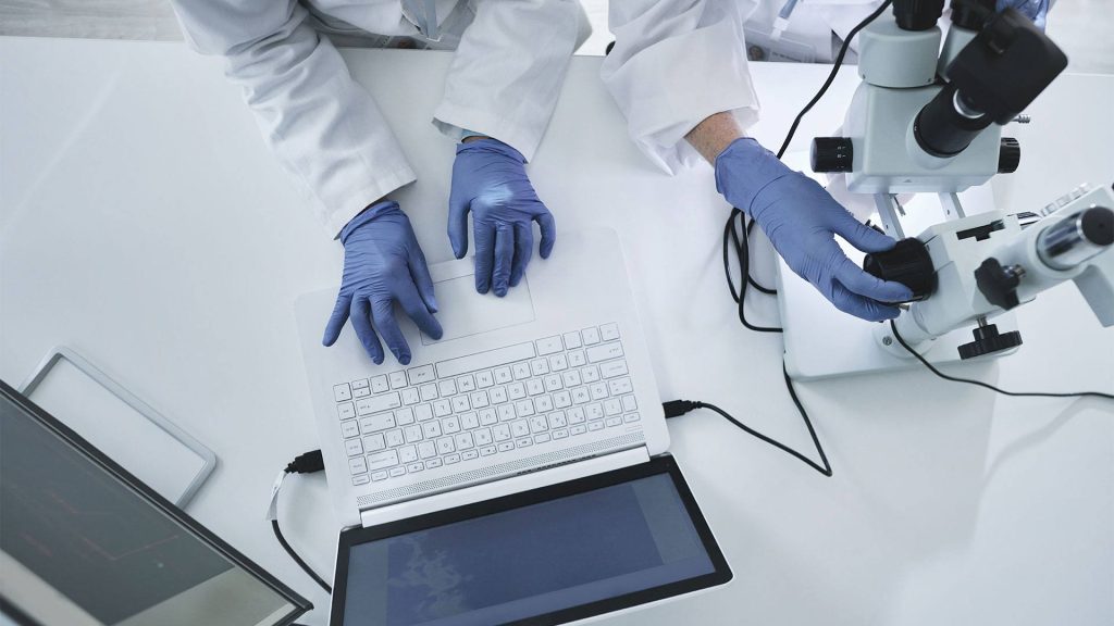 High angle shot of two unrecognizable scientists working in a lab. Getty Images