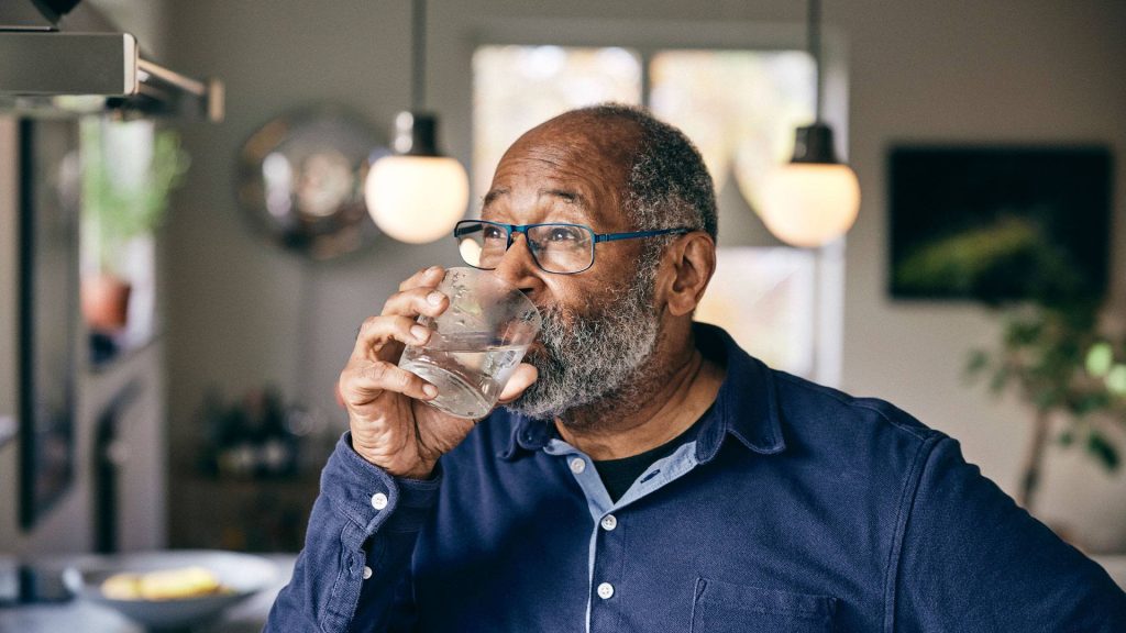 Photo of older man drinking water