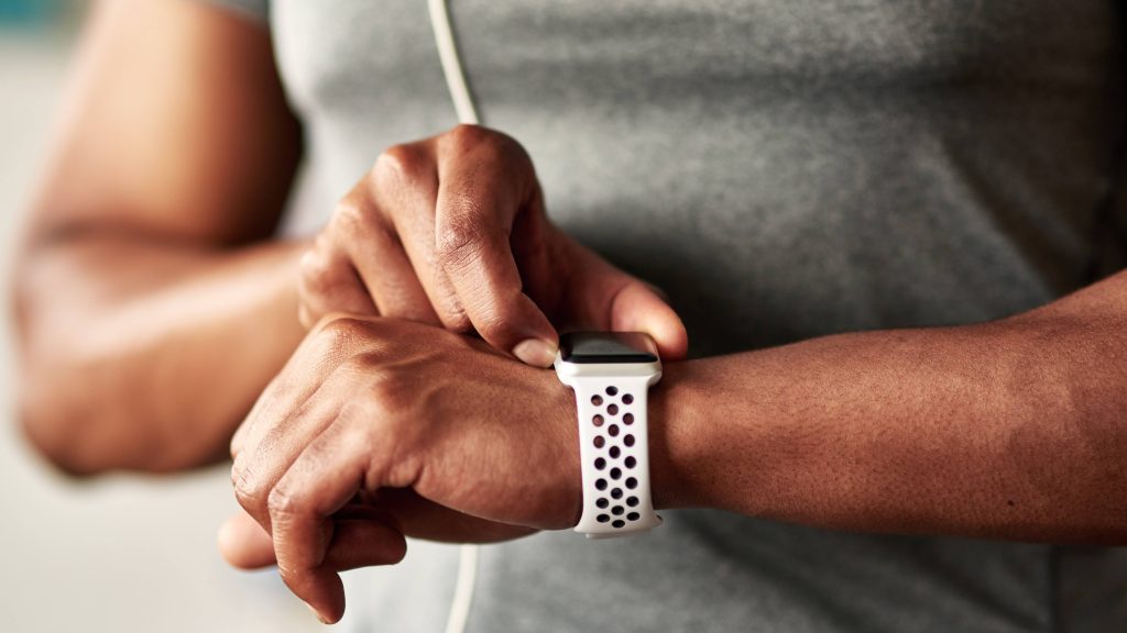 Man wearing a smart watch, wearable, checking heart rate numbers