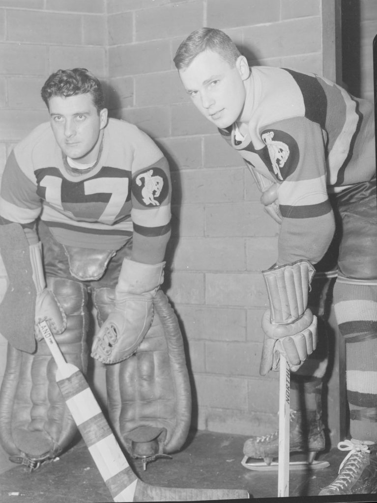 Bob Fleming and colleague with hockey gear
