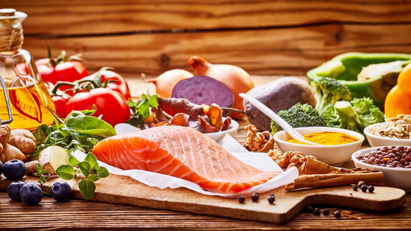 Foods that represent the Mediterranean diet incuding olive oil, nuts, salmon