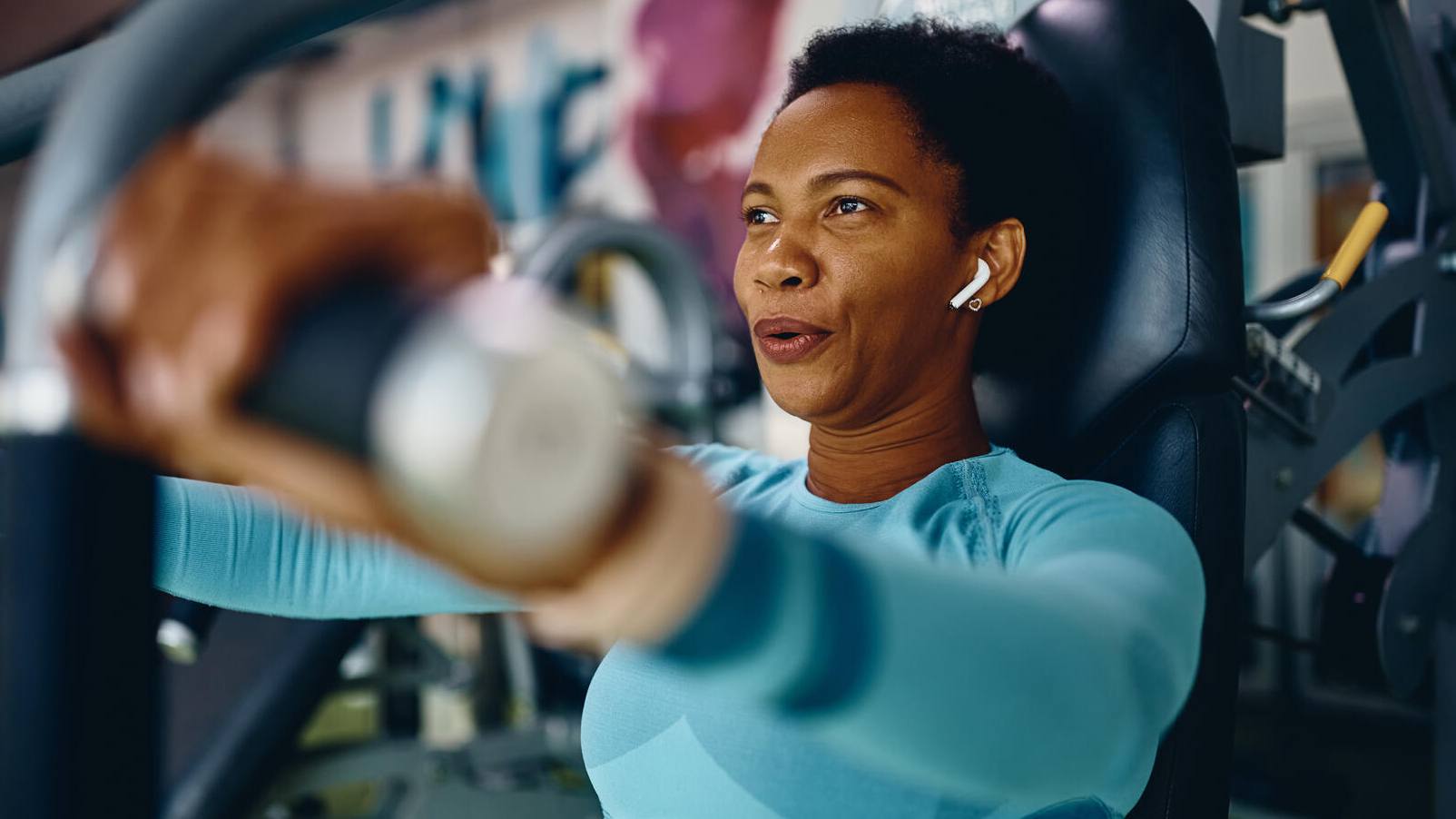 middle-aged woman on a machine at gym exercising, exercise, African American,