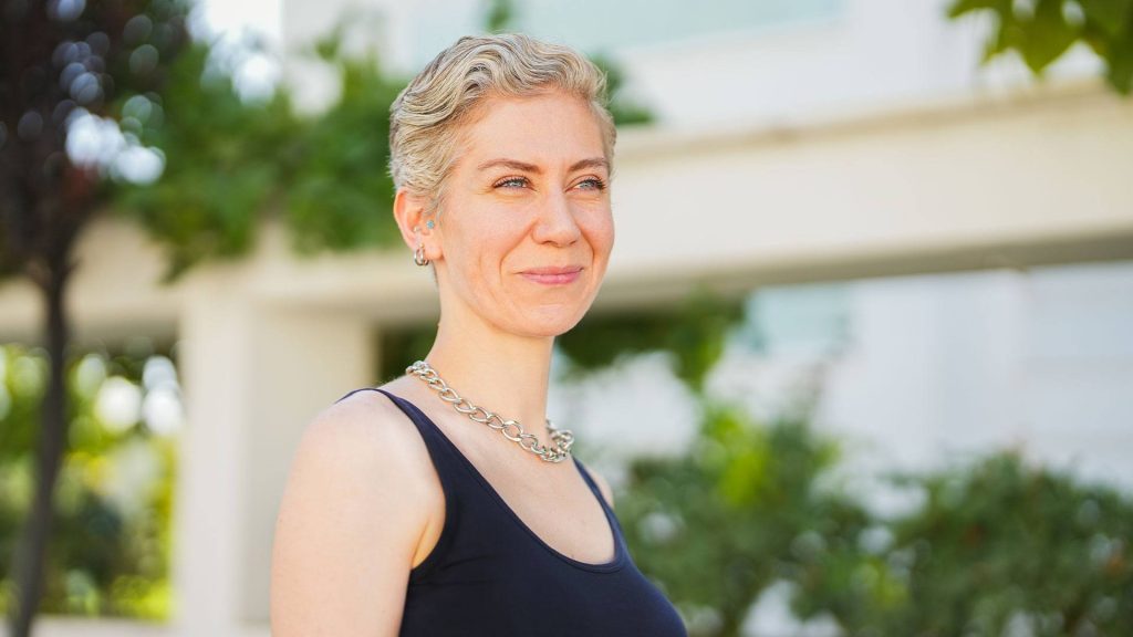 Photo of woman with short hair looks into distance.