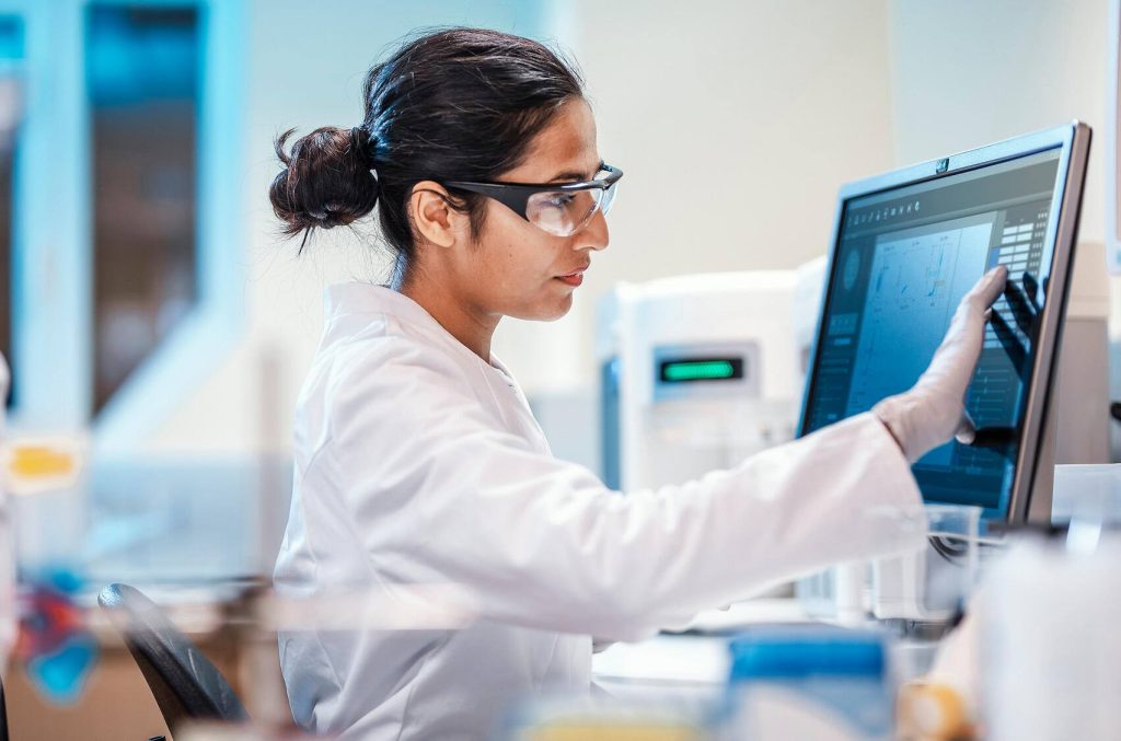 Scientist working in the lab using computer