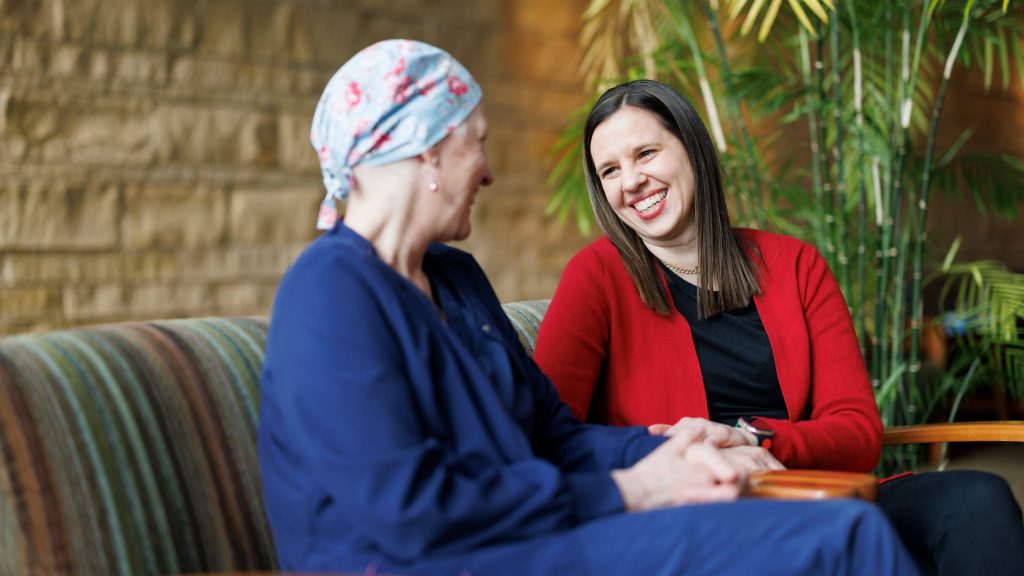 Shar Ballentine and Jenny Gottfredsen, both Mayo Clinic nurses,
 share a quiet moment, leaning on one another with the same compassion they offer their patients every day.