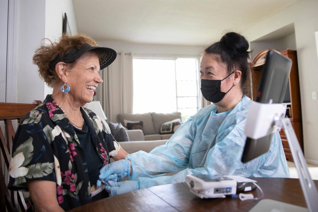Nurse connecting a dripline to the patient for home chemotherapy