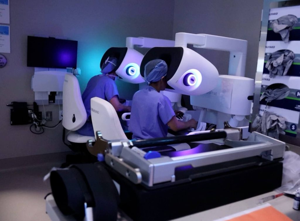 Robotic kidney transplant, surgeons at computer bay