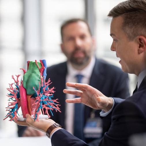 Dr. David Sanborn, right, discusses his research at a Transplant Summit.
