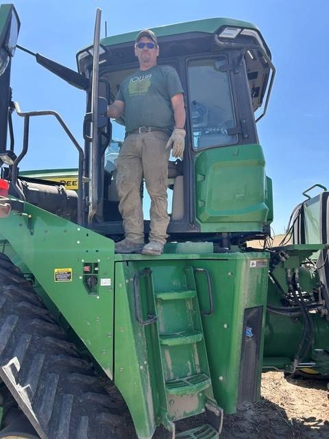Chad Rockow stands on a combine at his farm in Iowa. Photo courtesy of Chad Rockow.