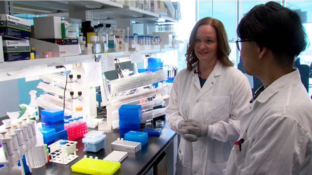 Margot Cousin, Ph.D., and Han Lee, a technologist in Dr. Cousin’s lab, work at a laboratory bench in Mayo Clinic’s N-of-1 Therapeutics Program.
